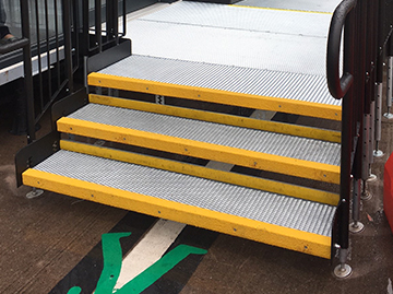 A metal step unit which has yellow nosing on each corner of the step. This is so that visually impaired people are able to identify the end of the step.