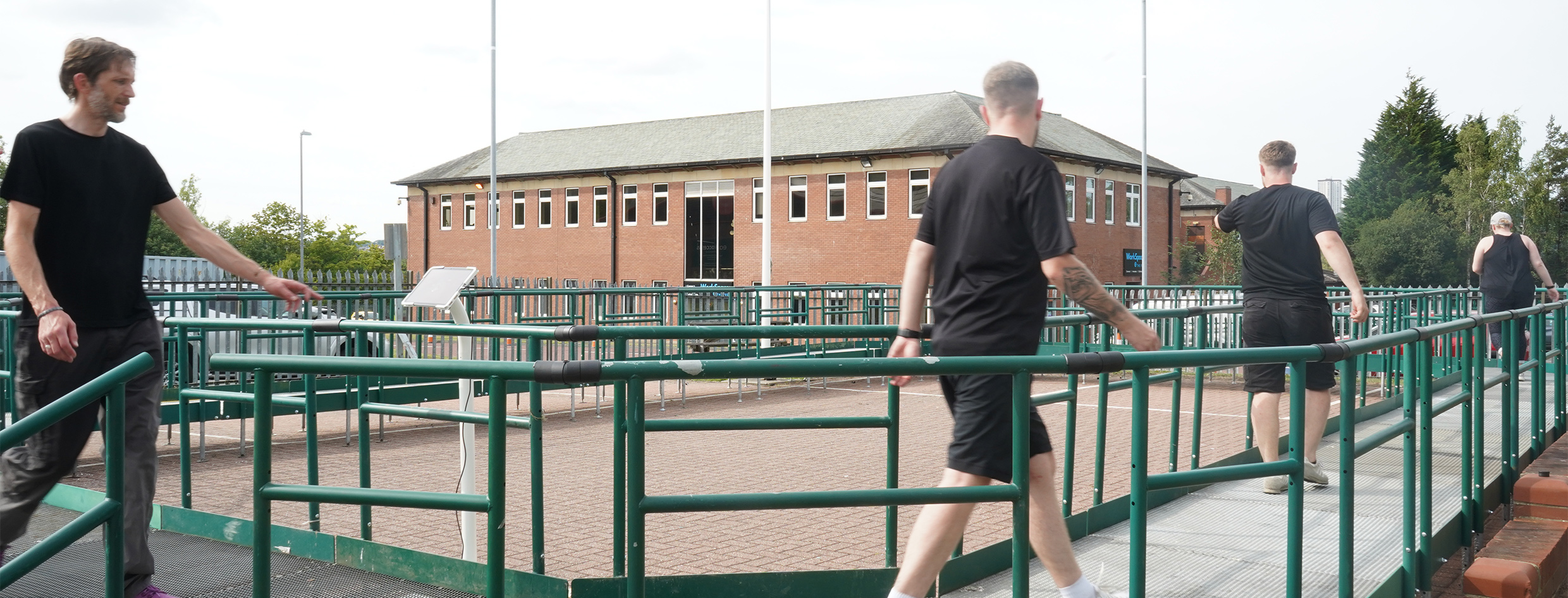 A modular platforms in the HQ car park with people walking round it. The platform goes in a circle, creating a circuit for the Rampathon.